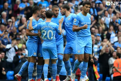 Manchester City players celebrating in the Etihad Stadium after a great start in the Premier League.