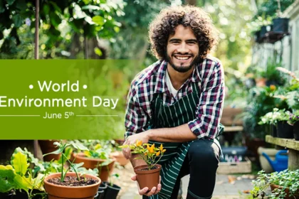 A young happy man holding a plant