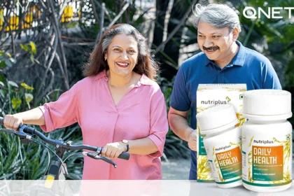 An elderly couple walking in the park with their bicycle