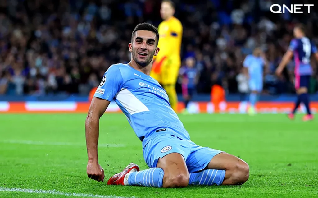 Ferran Torres sliding on his knees to celebrate after scoring a goal